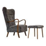 1960s, reupholstered Danish armchair, with stool, genuine sheepskin.