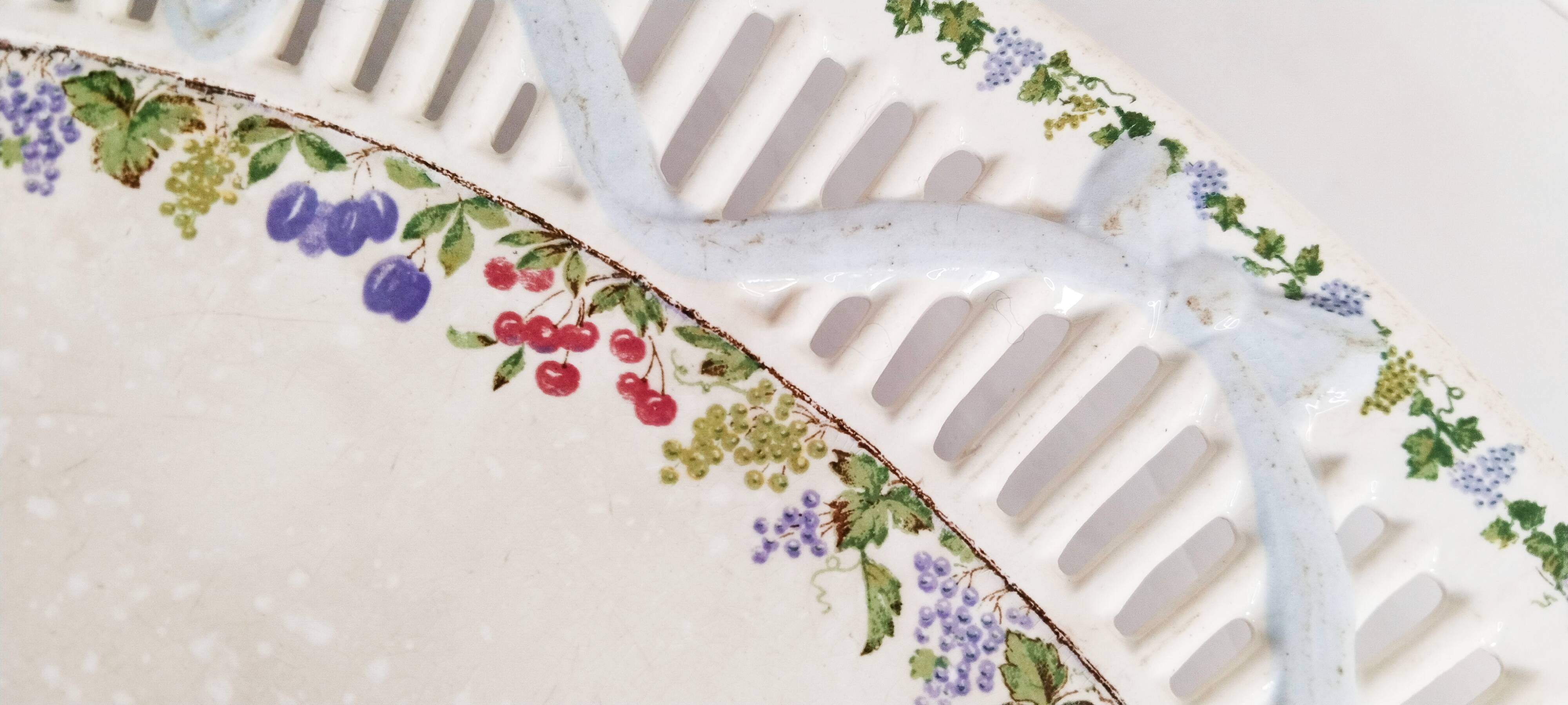 Oval dish in openwork earthenware from Sarreguemines, blue ribbon and fruit