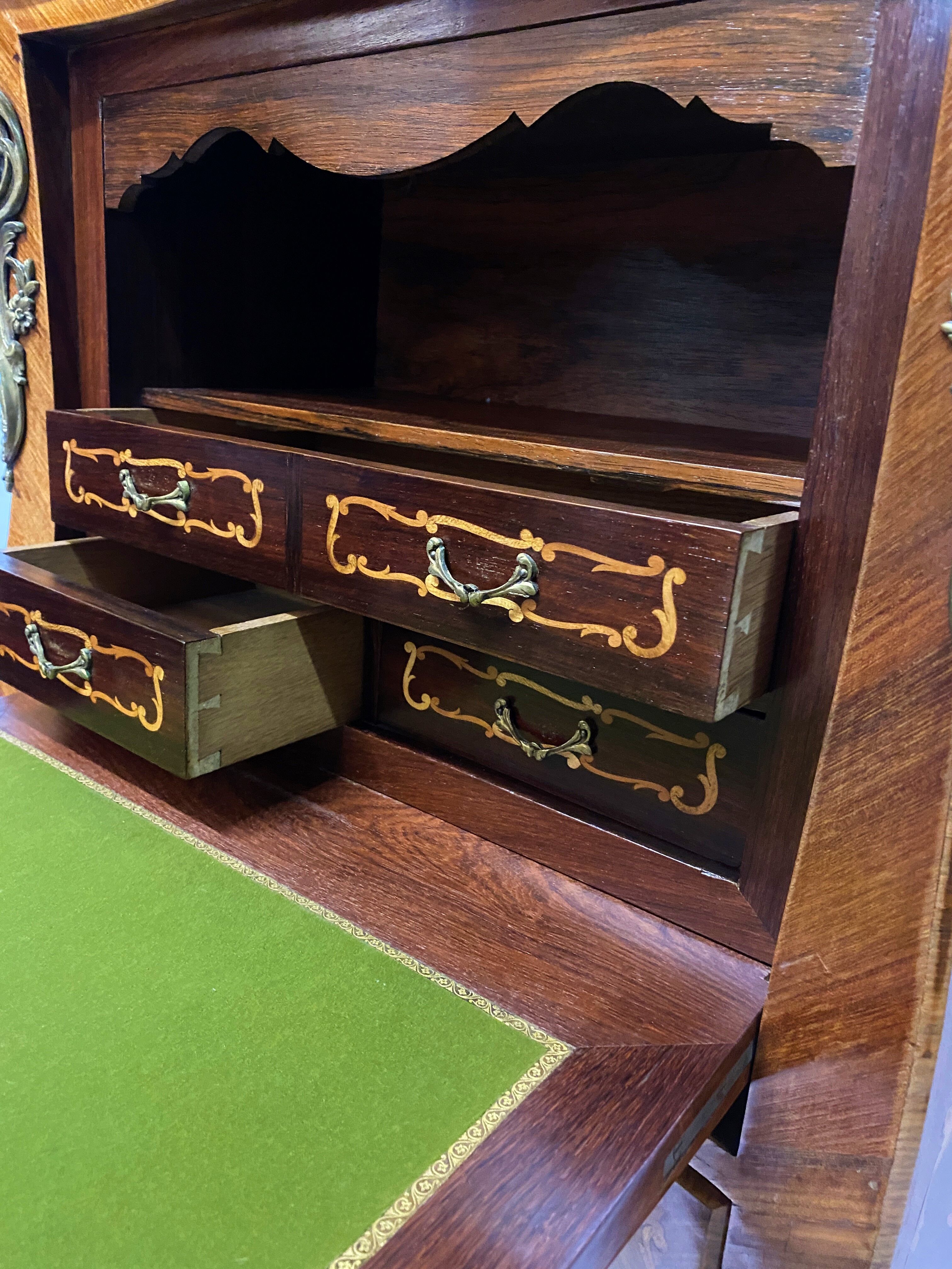 Curved secretary and inlaid with floral branches in Louis XV style