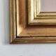 Miroir ancien en bois doré et cuivré
