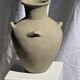 Light beige-grey Indonesian terracotta vase with 4 small handles and a high neck.
