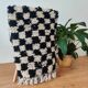 Small Berber rug with black tiles.