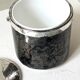 Vintage chrome metal ice bucket with black marbled design, 1970s style.