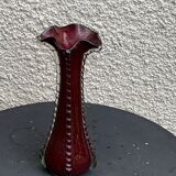 Burgundy red blown glass vase in the shape of a vintage corolla