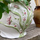 White ceramic pot cache of flower slip and old green foliage