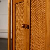 Small storage unit in cane and wood.