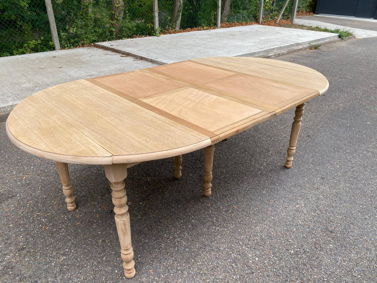 Round dining table with extendable leaves, Louis Philippe style, stripped in raw oak.