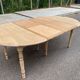 Round dining table with extendable leaves, Louis Philippe style, stripped in raw oak.