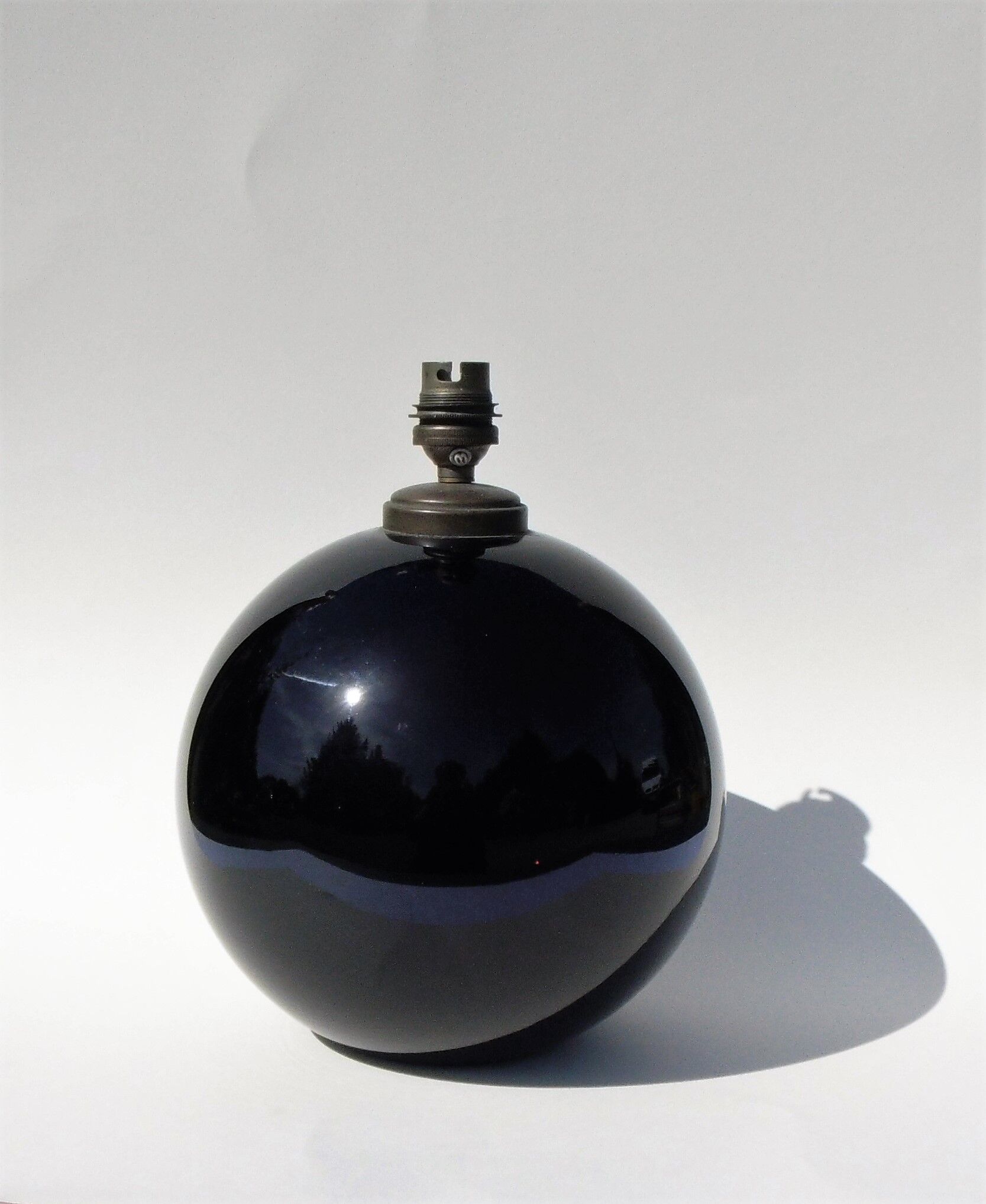 Old lamp foot shaped ball in black glass