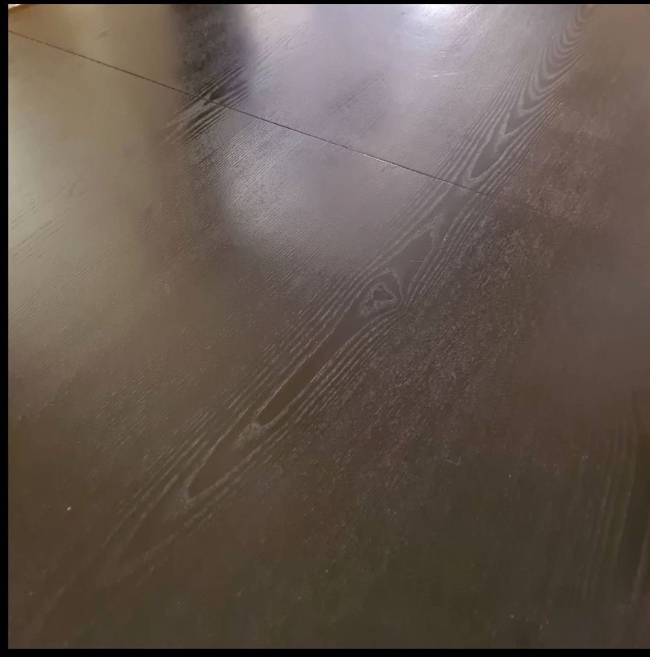 Blackened wooden dining table and chrome foot with integrated butterfly extension