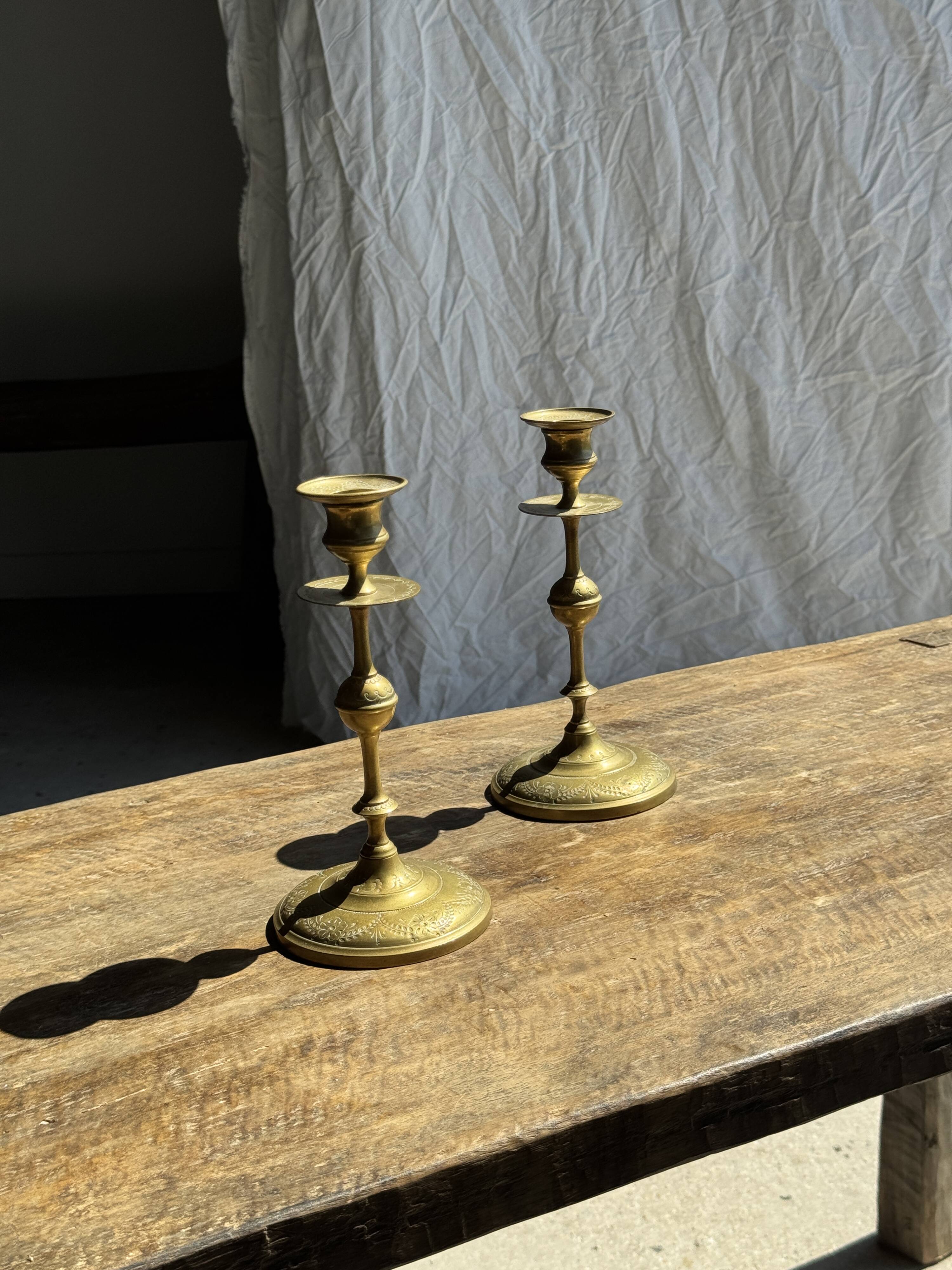 Pair of gilded candlesticks with engraved flower garland motifs H22