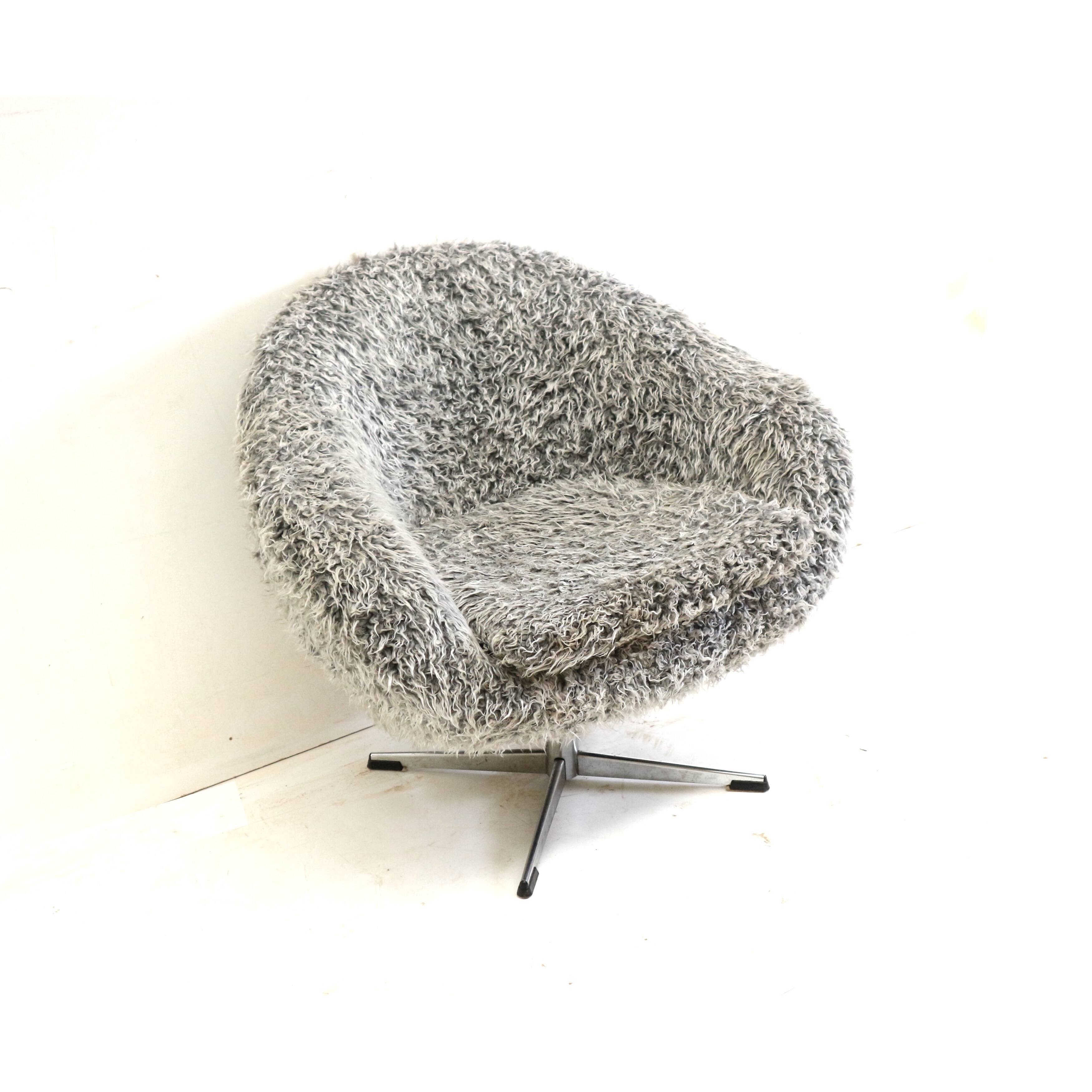 Grey swivel armchair with metal star base made in the 70s