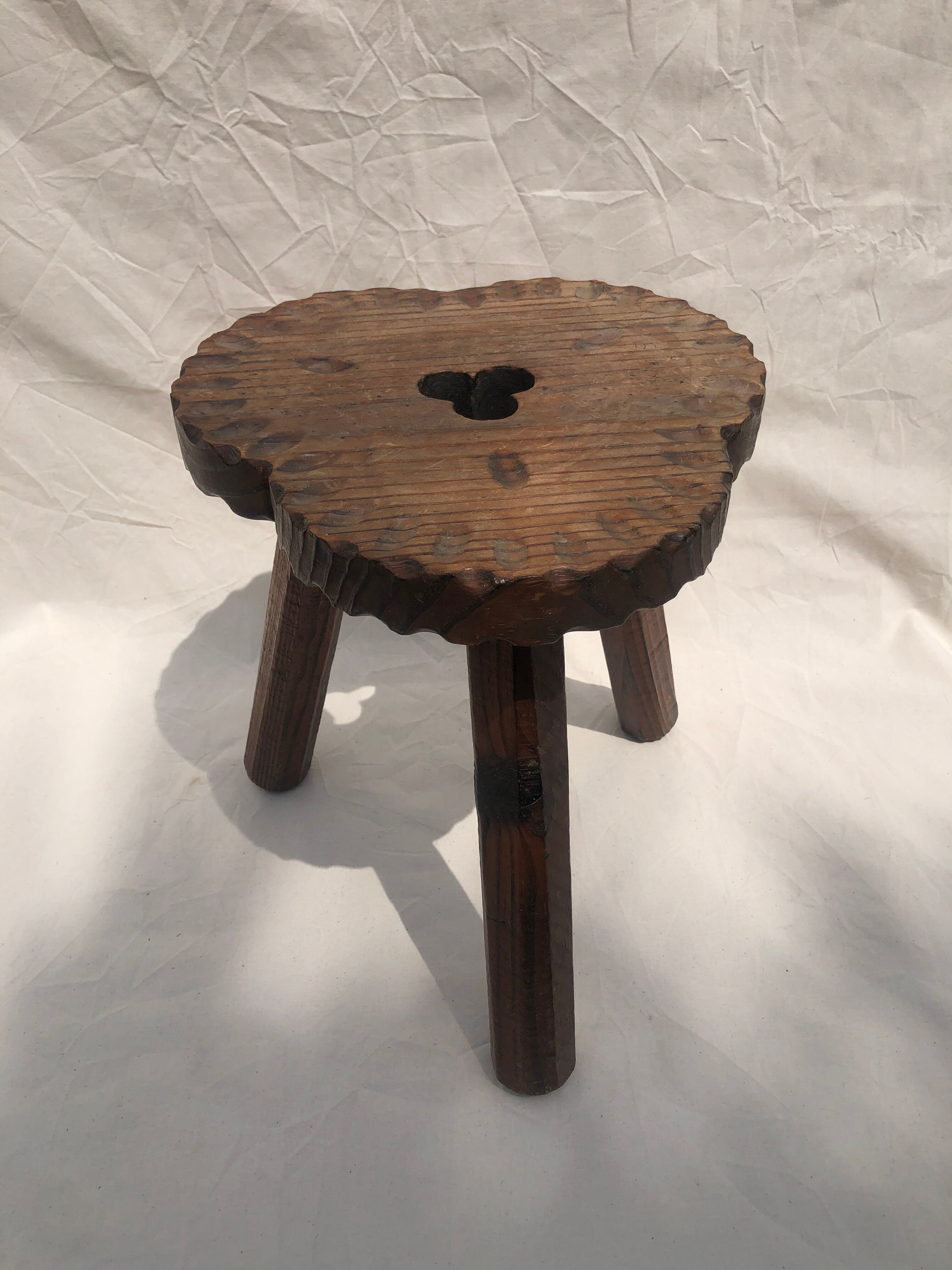 Chiseled wooden tripod stool