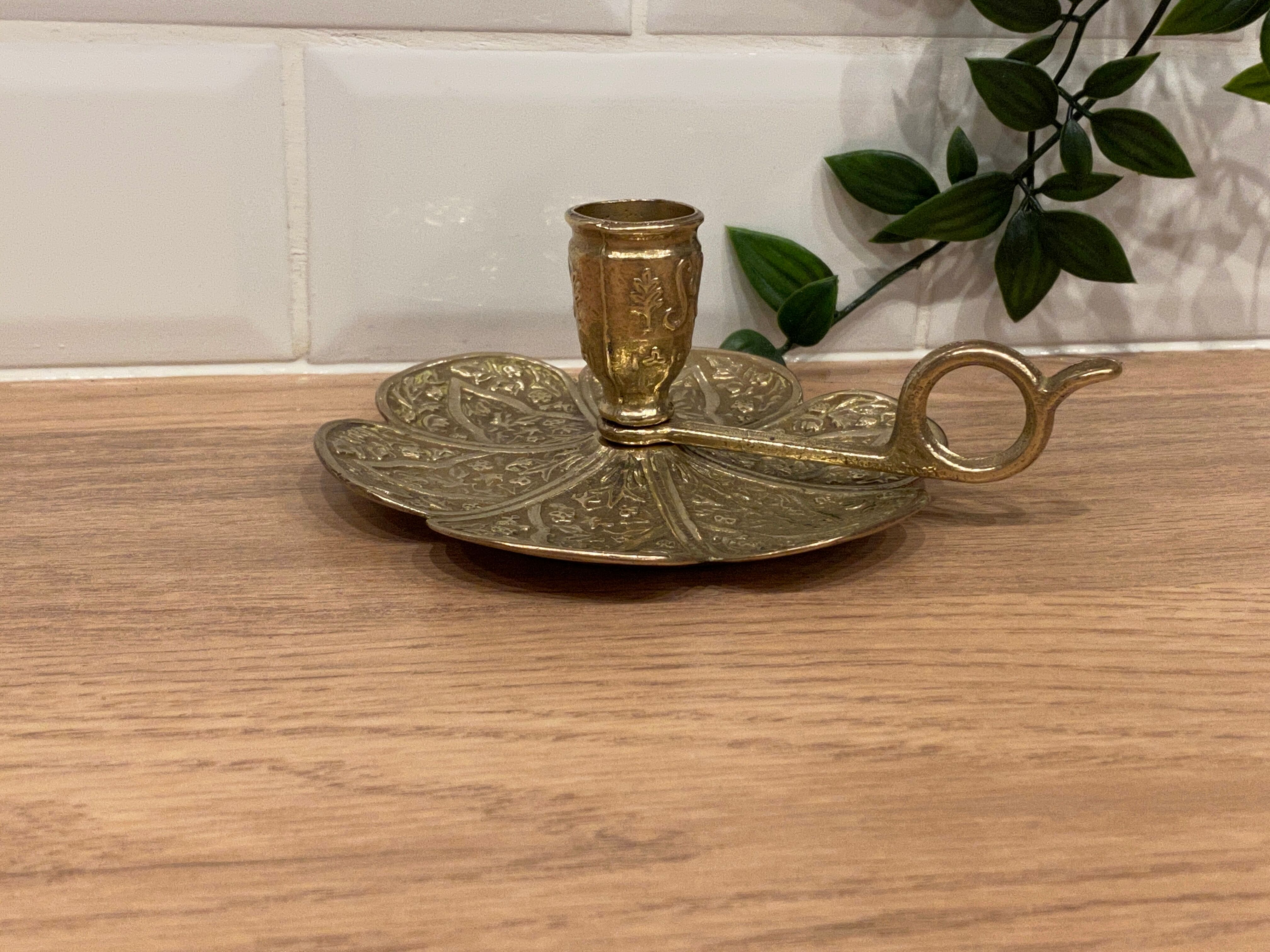 Brass candle holder on frame