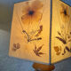 Turned wood lamp with a herbarium lampshade from the 1970s.