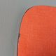 Chairs in red-orange formica and chrome metal.