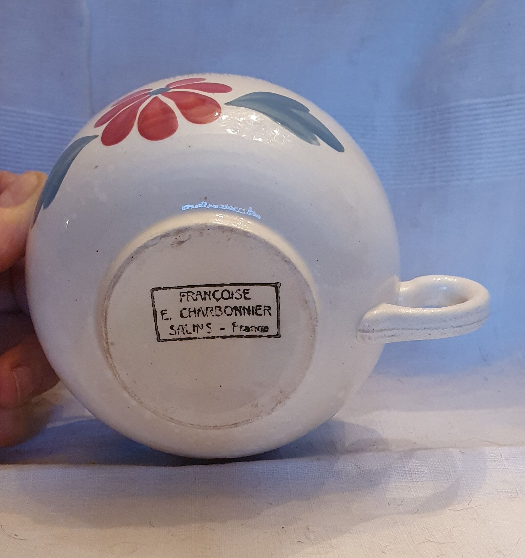 Old big cup in faience with flower decoration
