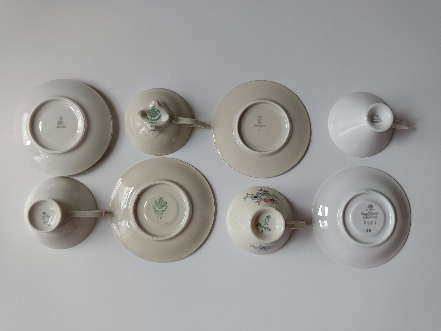 Set of mismatched fine porcelain cups signed with saucer