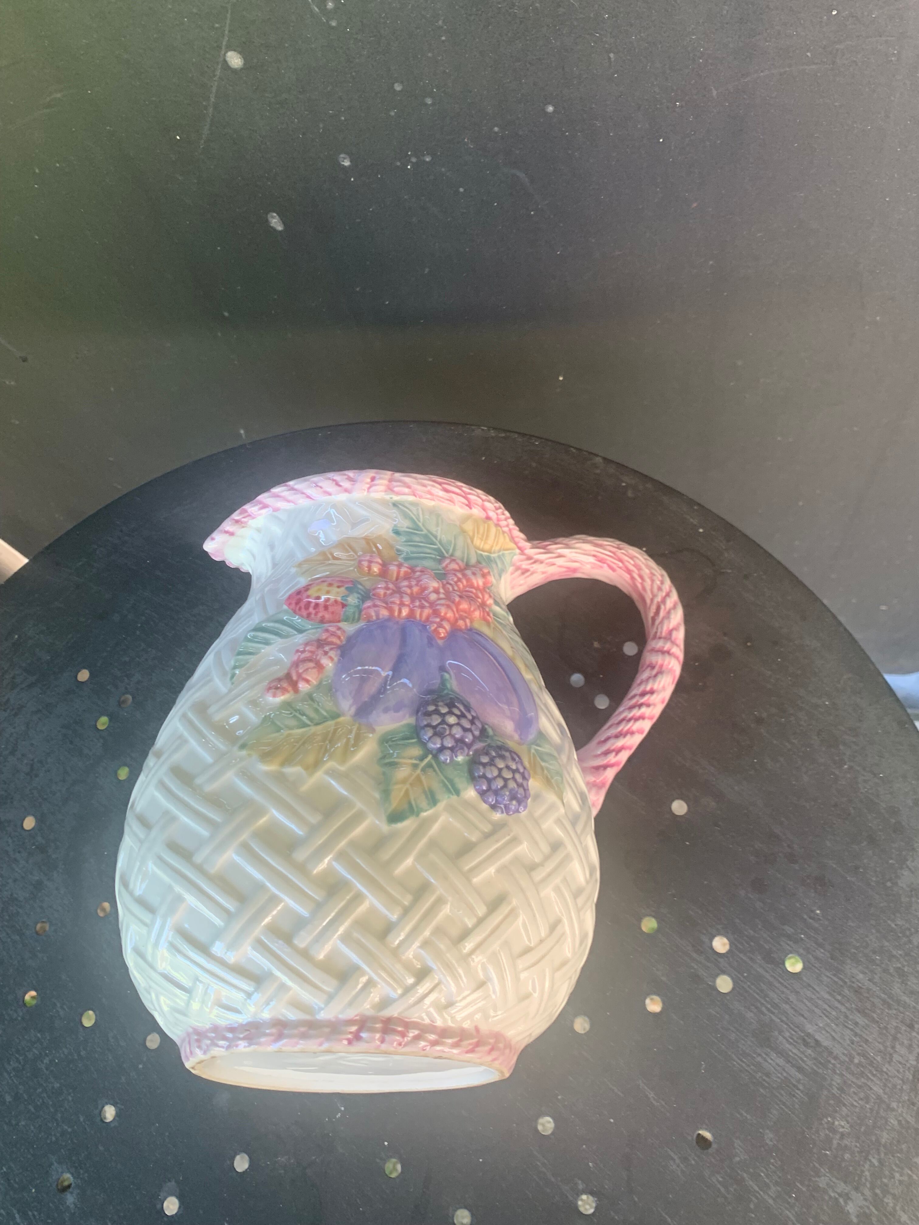 Glazed ceramic slip jug with vintage basket and fruit motif