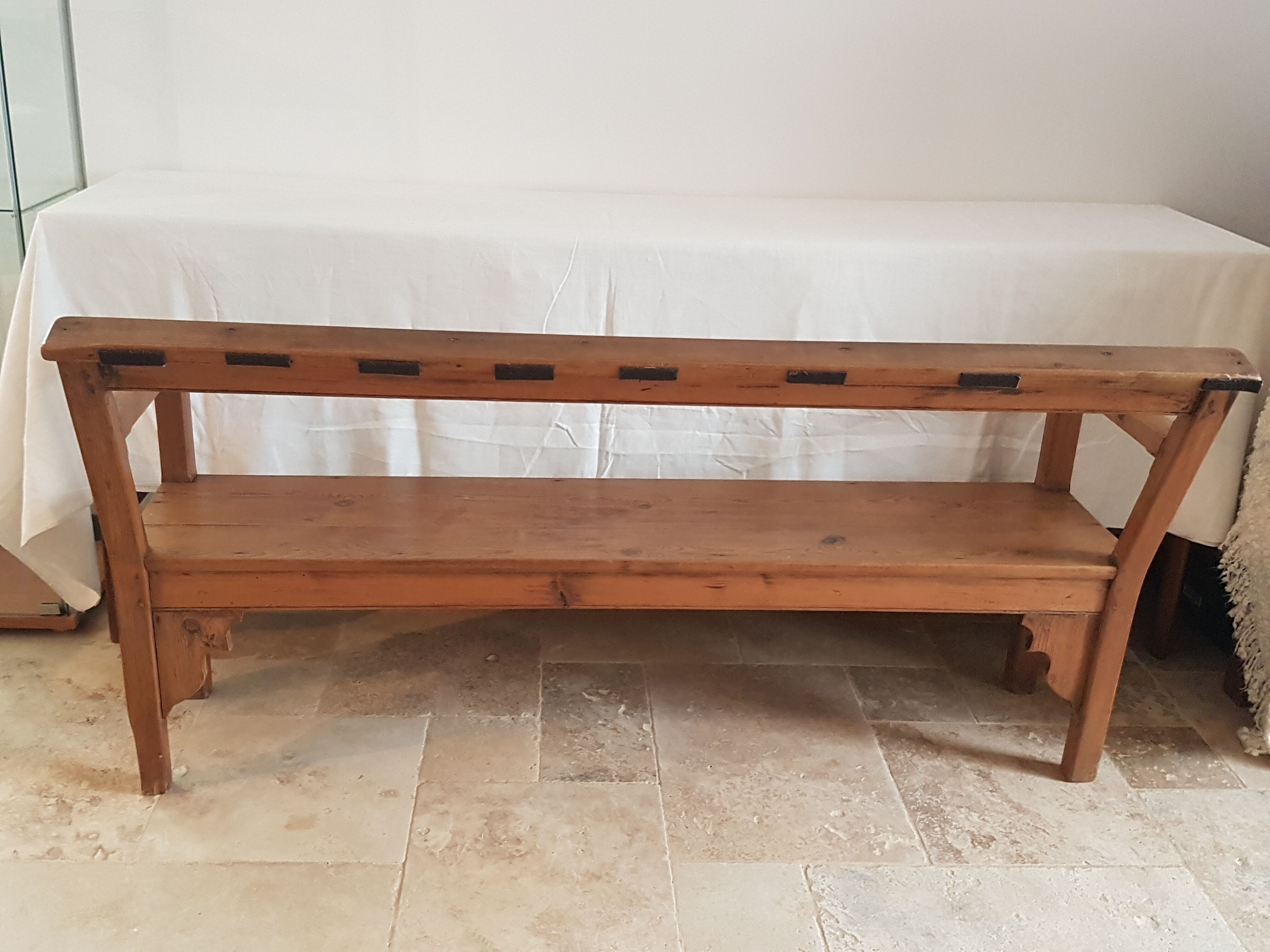 Church bench in fir tree with armrests