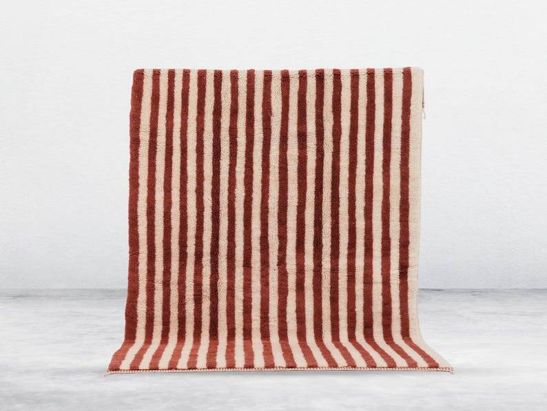 A handmade Moroccan striped terracotta rug, 150/250cm