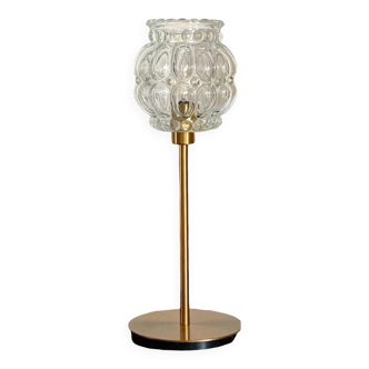 Table lamp with vintage bubbled glass globe and a golden foot