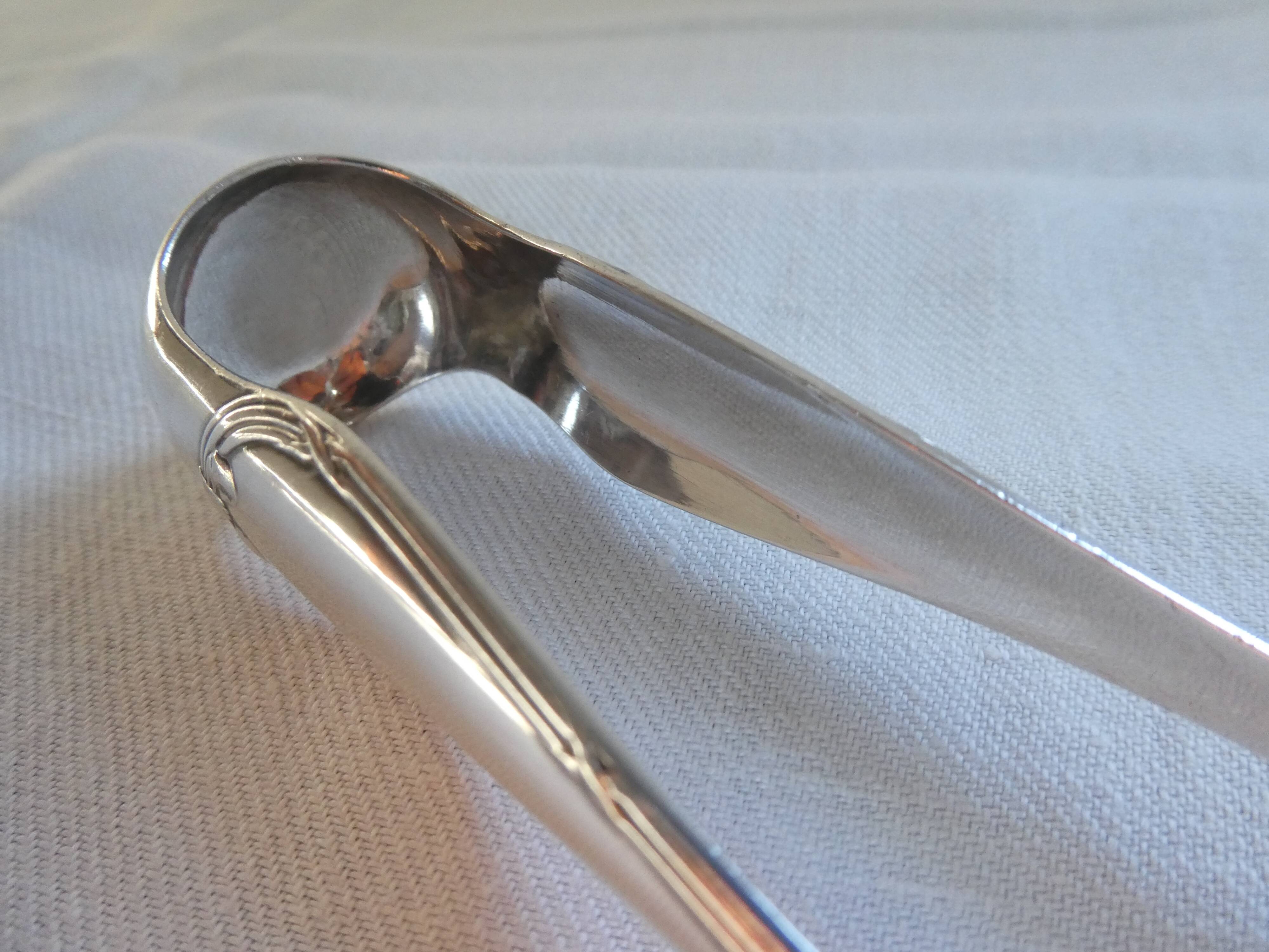 Christofle Silver-plated metal sugar tongs with crossed ribbon bow design