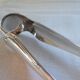 Christofle Silver-plated metal sugar tongs with crossed ribbon bow design