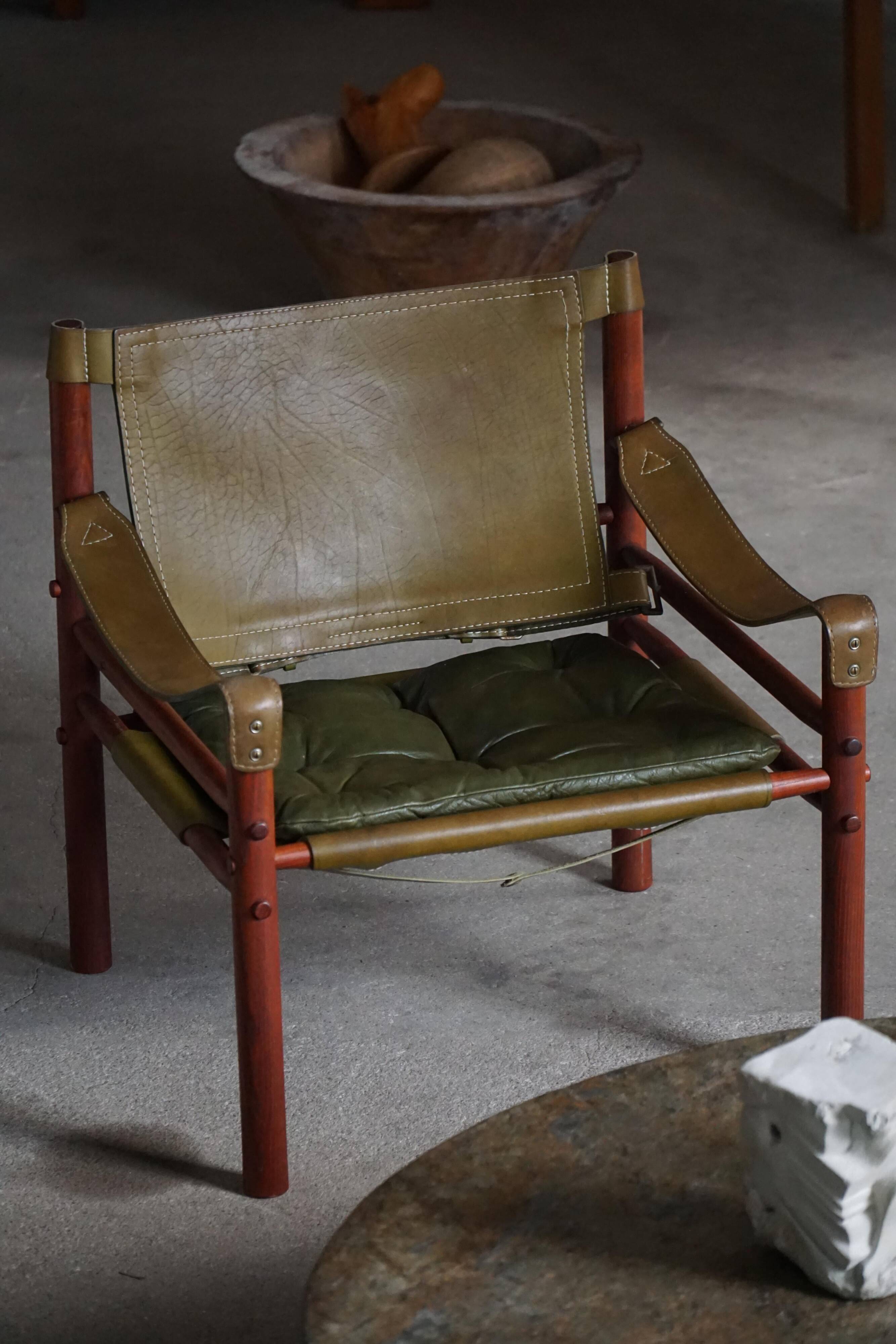 Arne Norell, Pair of "Sirocco" Safari armchairs in ash and green leather, 1960s.