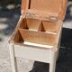 Shoe polish stool with round top and aluminum legs.