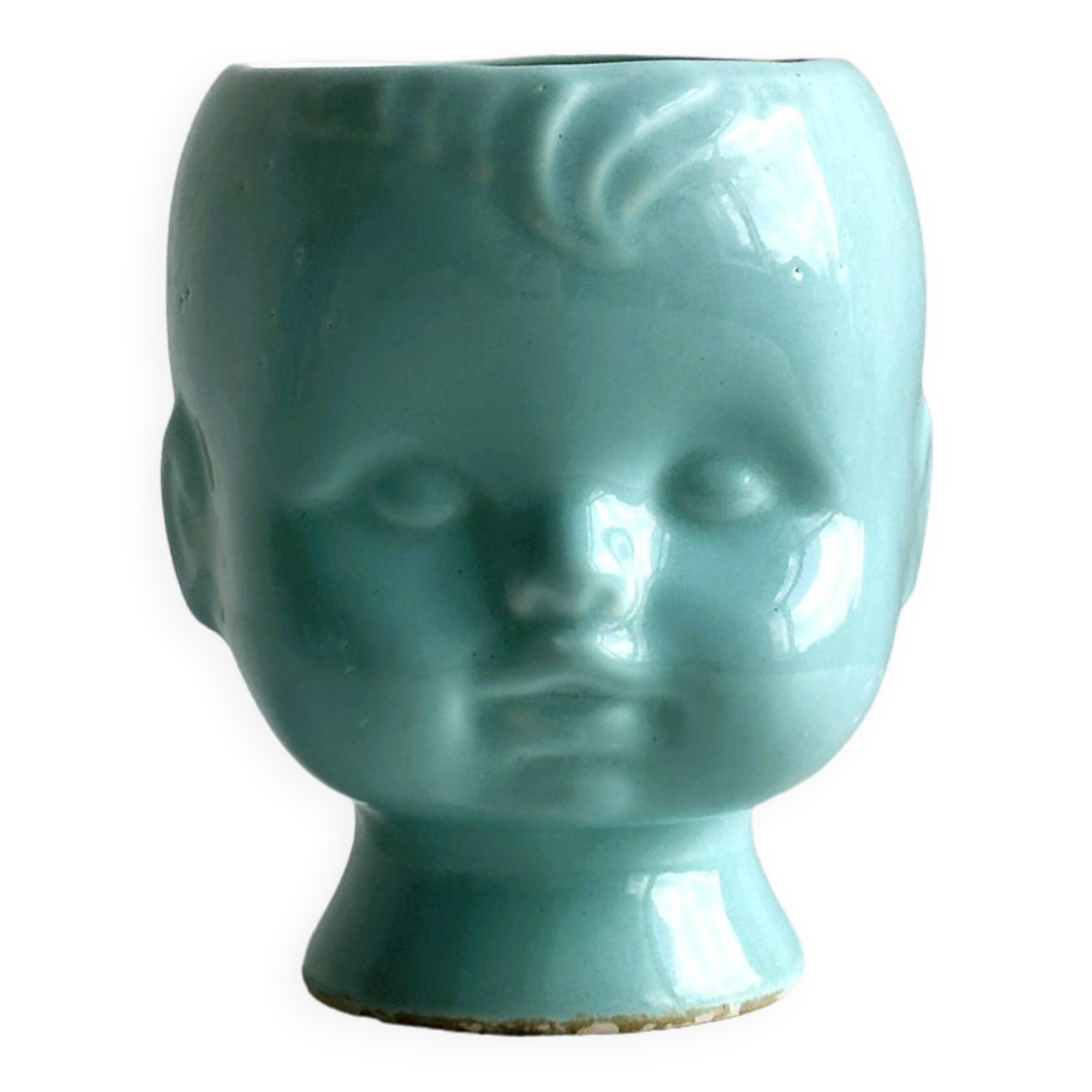 Turquoise plant pot in the shape of a vintage doll's head.