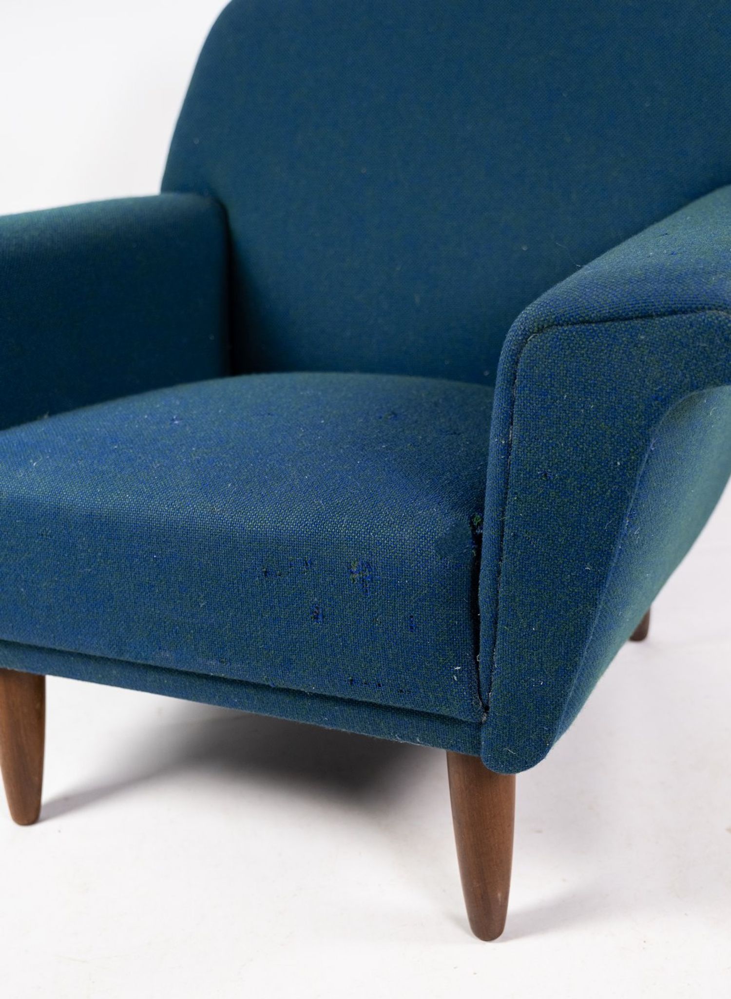 Armchair upholstered with dark blue wool fabric and legs in dark wood, of danish design, 1960s