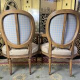 Paire de fauteuils médaillon d’époque Louis XVI