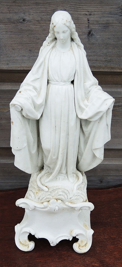 Ancient statuette of the virgin with the serpent in biscuit