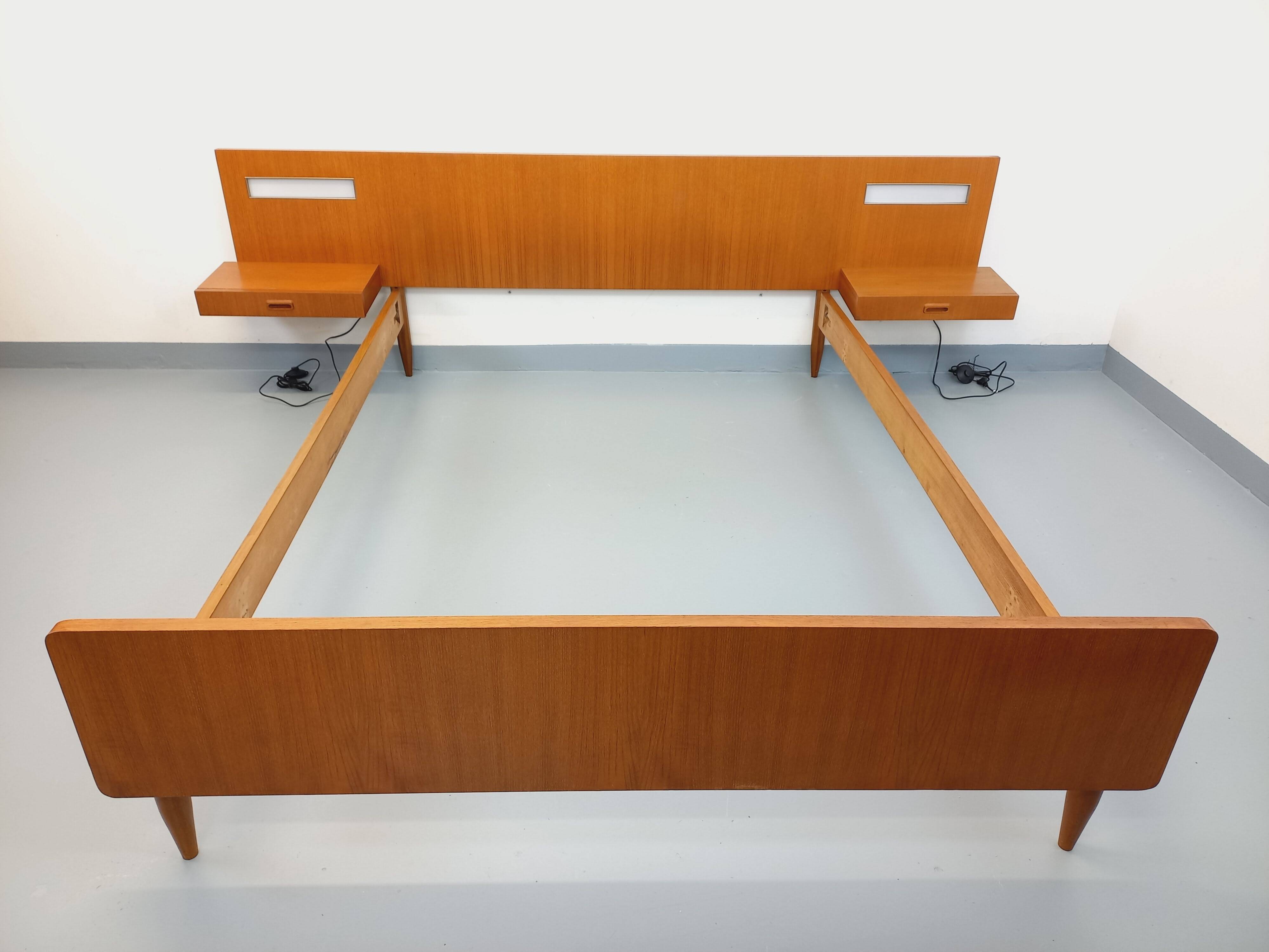 Double bed in vintage Scandinavian style from the 1960s with bedside tables.