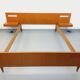 Double bed in vintage Scandinavian style from the 1960s with bedside tables.