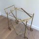 Neoclassical brass trolley with removable trays.