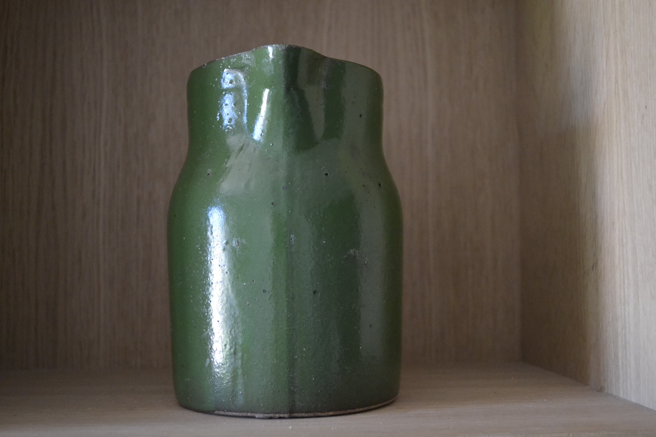 Green pitcher in sandstone