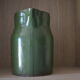 Green pitcher in sandstone