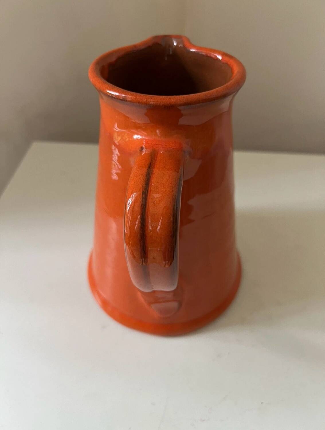 Vintage orange glazed terracotta pitcher