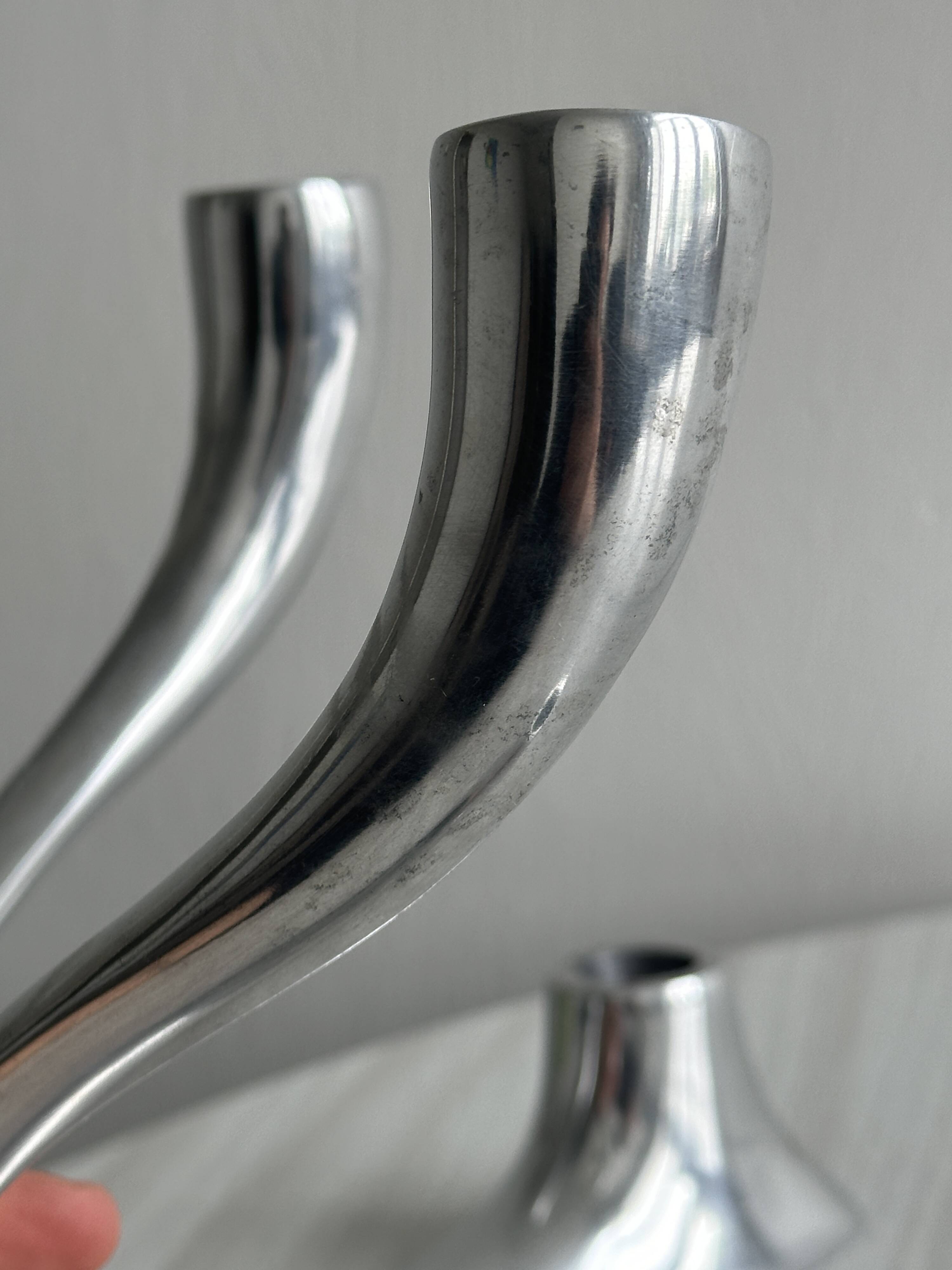 Pair of designer candlesticks in chromed metal