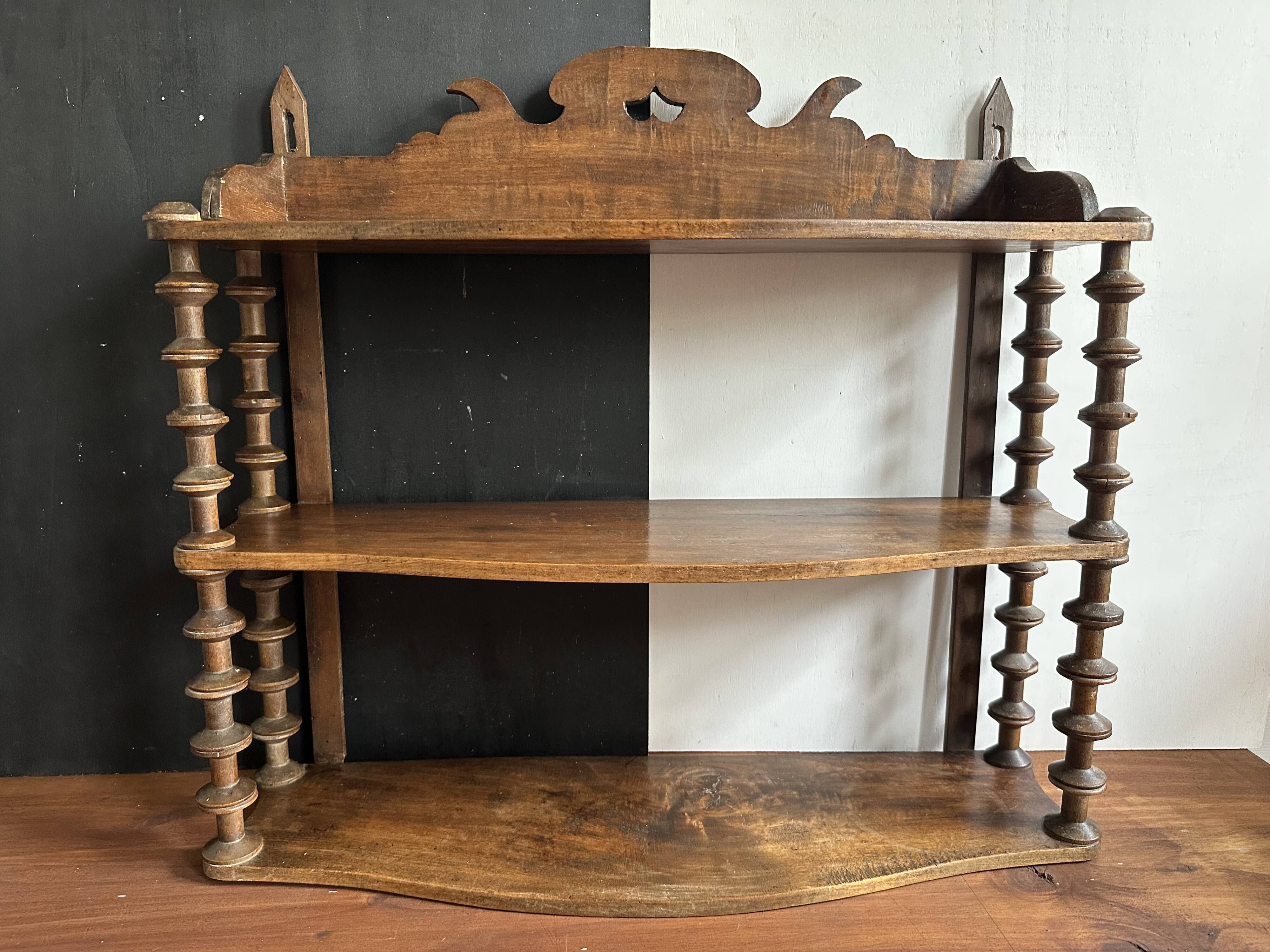 Antique wall shelf made of turned wood and spools of thread, late 19th century.