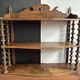 Antique wall shelf made of turned wood and spools of thread, late 19th century.