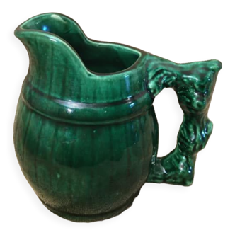 Porcelain pitcher in the shape of a barrel, with its handle that looks like a vine stock