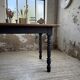 Oak farmhouse table with turned black legs.