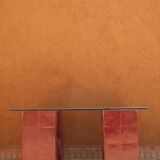 Modern coffee table in burgundy zellige with a tempered glass top.