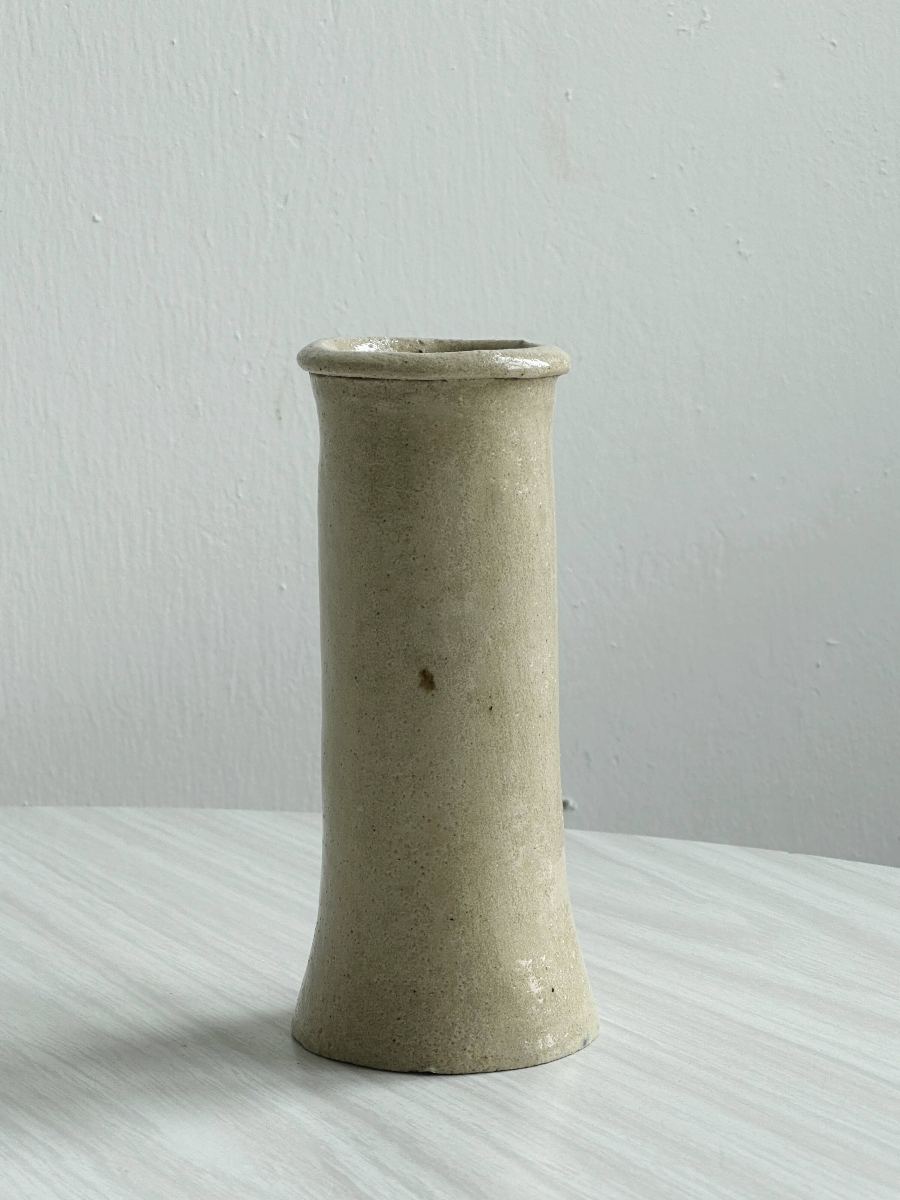 Minimalist beige ceramic vase.