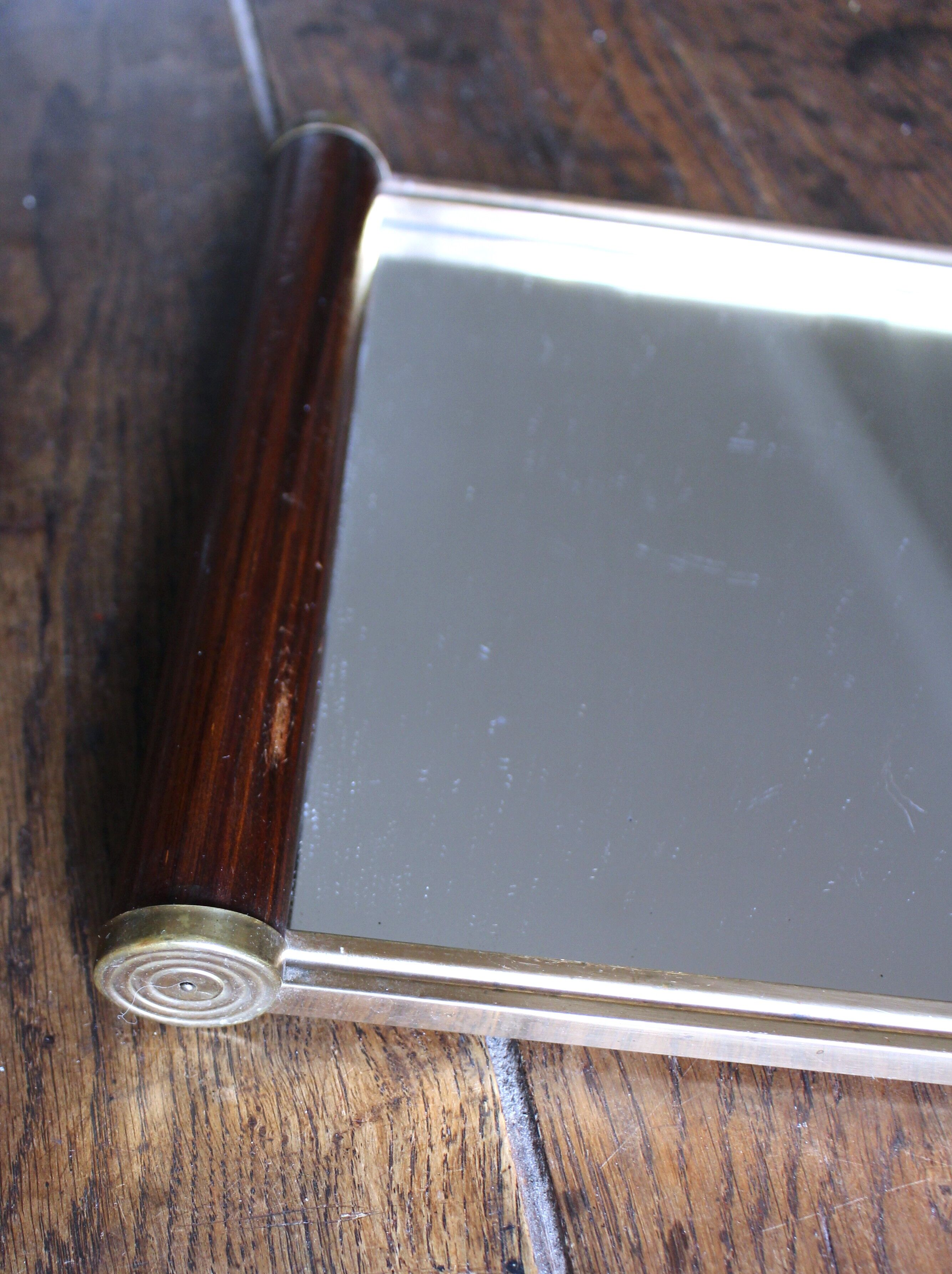 Rectangular mirror tray with wooden handles and gilding.