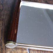 Rectangular mirror tray with wooden handles and gilding.