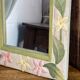 Carved wooden mirror, colourful floral decoration.